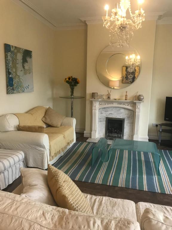 a living room with two beds and a fireplace at Clifton Lodge in Lytham St Annes