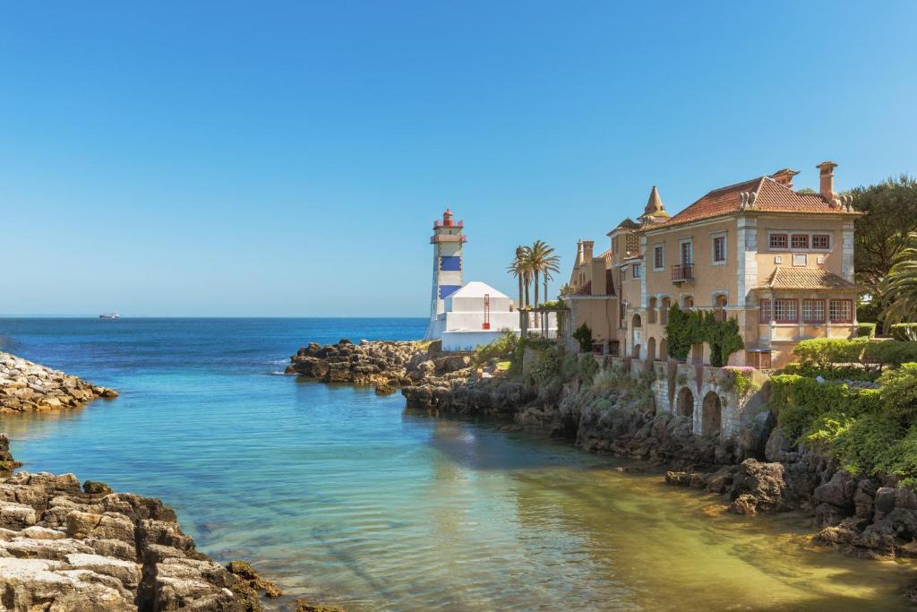 a river with a light house and a lighthouse at Beach House Old Town in Cascais
