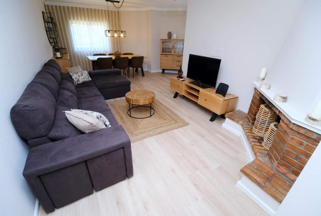 a living room with a couch and a fireplace at Diamante house com garagem privada in Braga