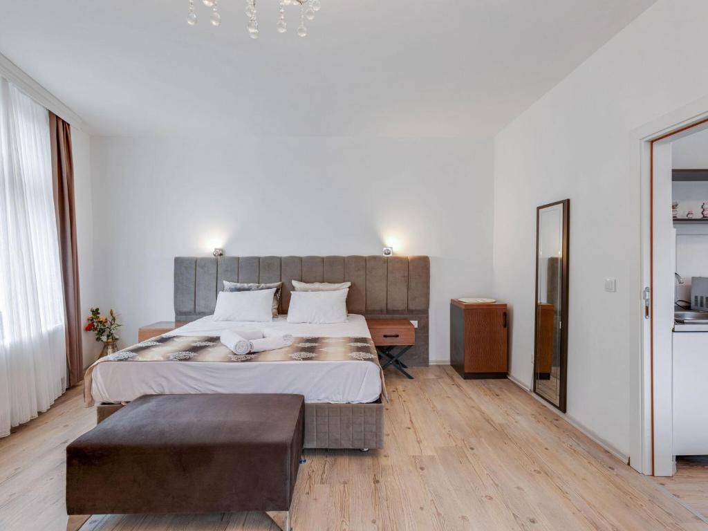 a bedroom with a large bed and a large mirror at Deluxe Apartment in Oberhausen with Breakfast in Oberhausen