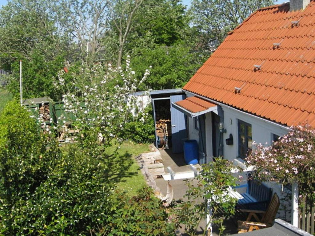 a small blue house with an orange roof at 4 person holiday home in Bramming in Bramming