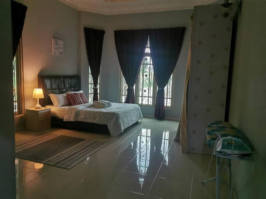 a bedroom with a bed and a large window at 3R3B in Kota Bharu near Datu River in Kota Bharu