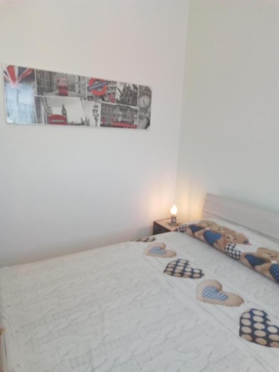 a bedroom with a bed with a picture on the wall at Villa Anna Maria in Polignano a Mare