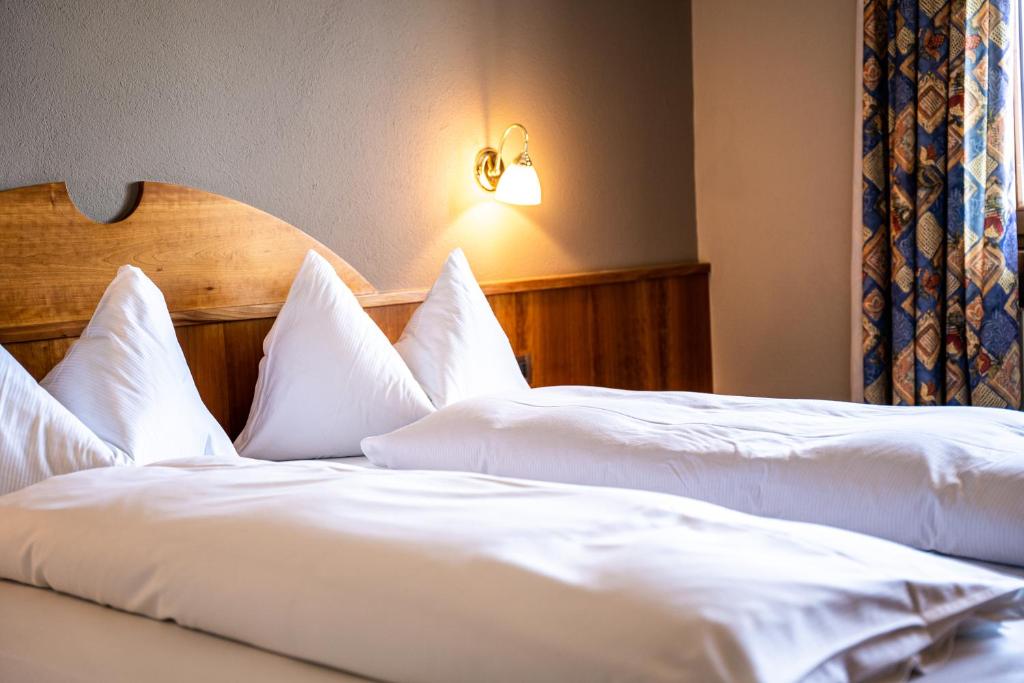 A bed or beds in a room at PanoramaHotel Penegal