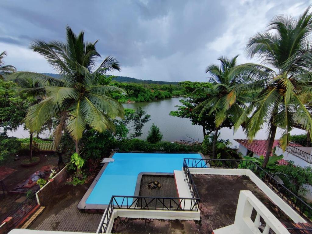 a view of the river from the balcony of a villa at Luxury 3-BHK Villa with infinity Pool in Old Goa