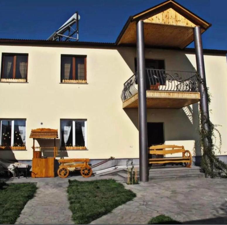 a large white house with a porch and a balcony at Green Training Center in Dzoraghpʼyur
