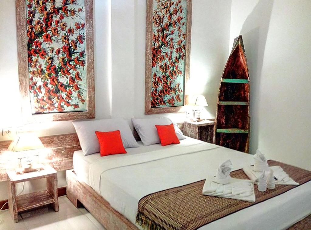 a bedroom with a bed with a christmas tree on it at Green Banana in Gili Trawangan