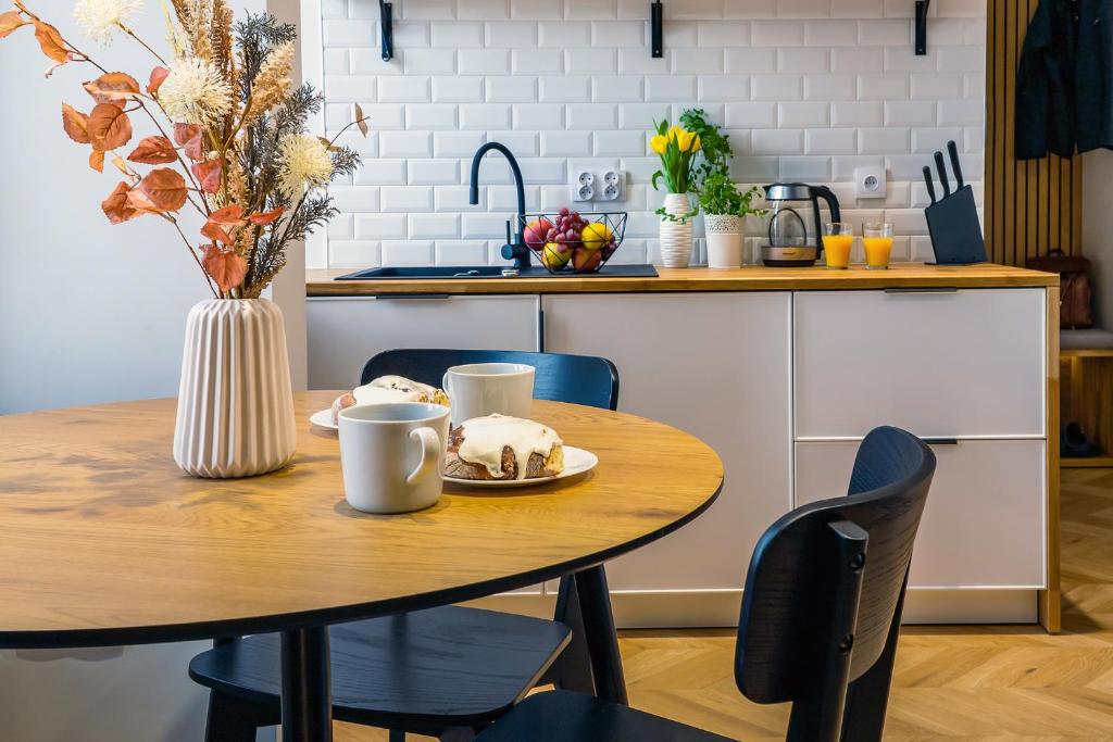 a kitchen with a table with a cake on it at Hillside7 Micro-Loft in Bielsko-Biała