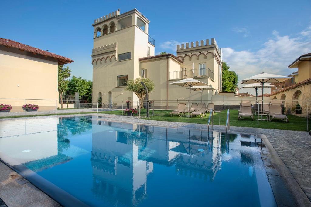 a swimming pool in front of a building at VILLA BERNASCONI in Narzole