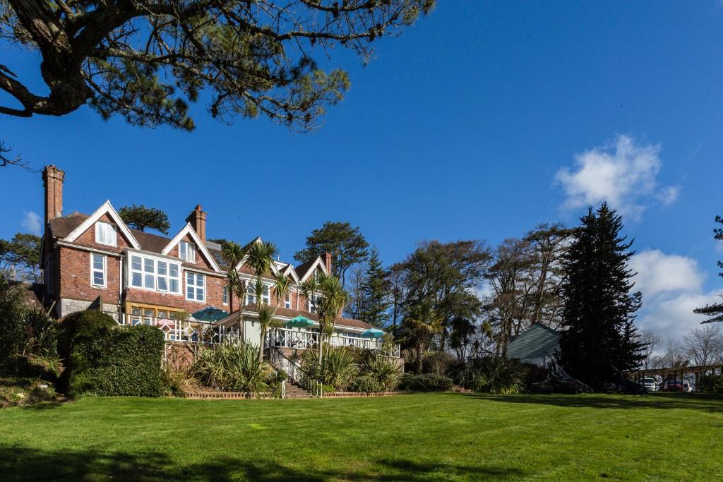 a large house with a lawn in front of it at Orestone Manor in Torquay