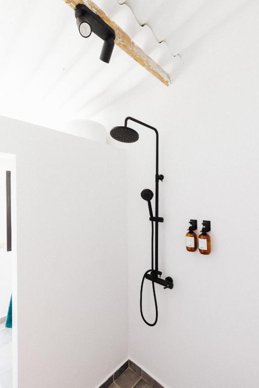a bathroom with a shower in the ceiling at La Casa de La Caleta by Taller96 - El Hierro Island - in La Caleta