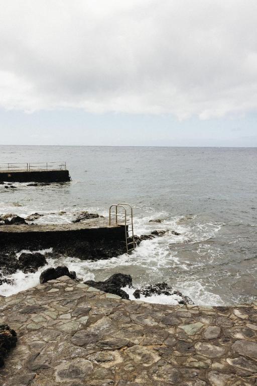 a view of the ocean from a pier at La Casa de La Caleta by Taller96 - El Hierro Island - in La Caleta