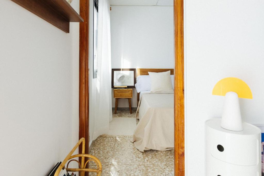a bedroom with a bed and a mirror at La Casa de La Caleta by Taller96 - El Hierro Island - in La Caleta