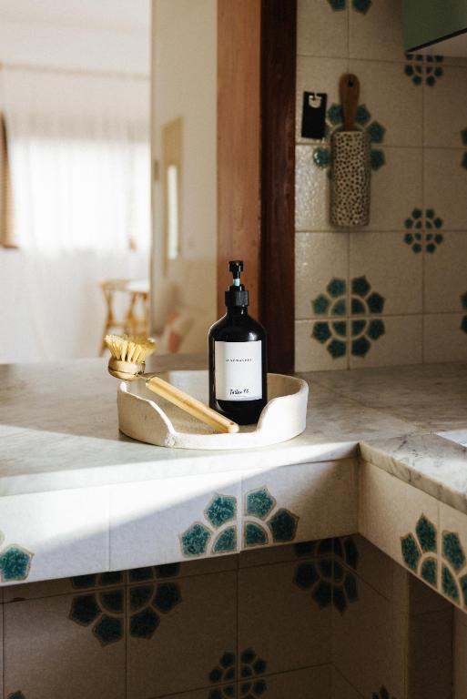 a bottle of soap sitting on a sink in a bathroom at La Casa de La Caleta by Taller96 - El Hierro Island - in La Caleta