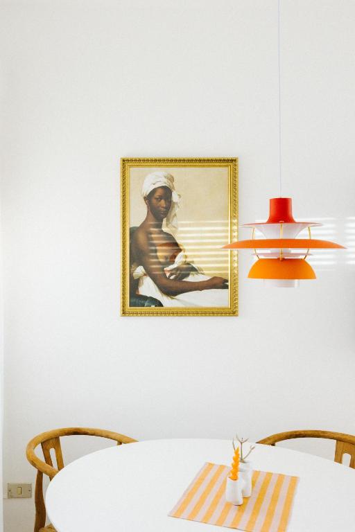 a painting of a man on a wall next to a table at La Casa de La Caleta by Taller96 - El Hierro Island - in La Caleta