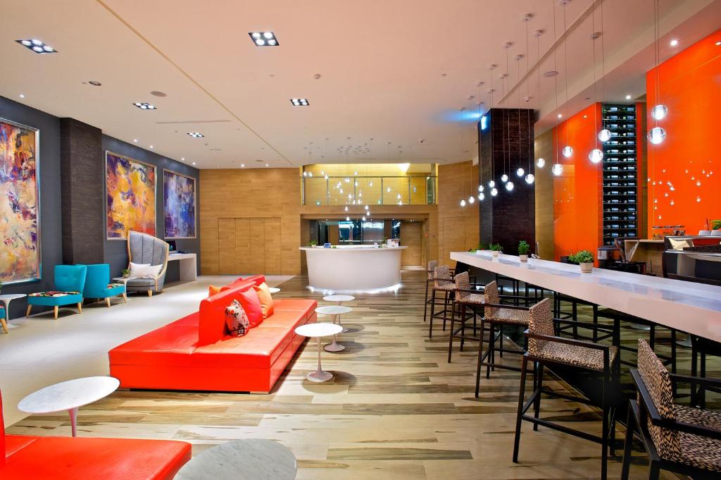 a restaurant with a red couch and a bar at FX INN Kaohsiung Zhonghua Road Branch in Kaohsiung