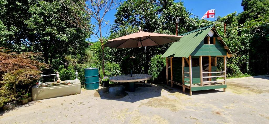 a small play structure with a table and an umbrella at Apartments Sunset Paradise in Makhinjauri