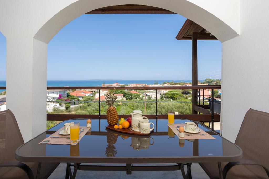 a dining table with a view of the ocean at Vallia's Seaview Complex in Argassi