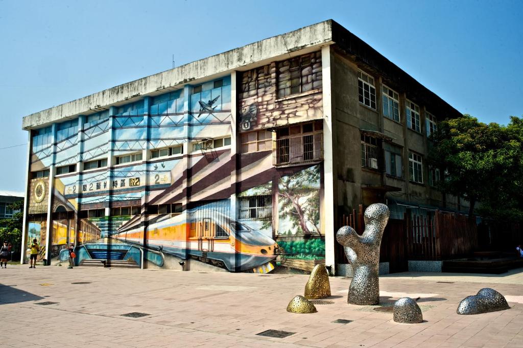 a building with a painting on the side of it at FX INN Kaohsiung Zhonghua Road Branch in Kaohsiung