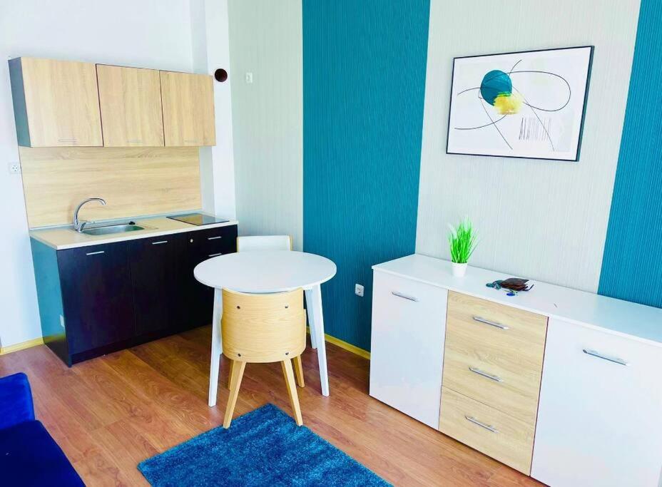 a small room with a table and a kitchen at Sunny Day 6 in Sunny Beach