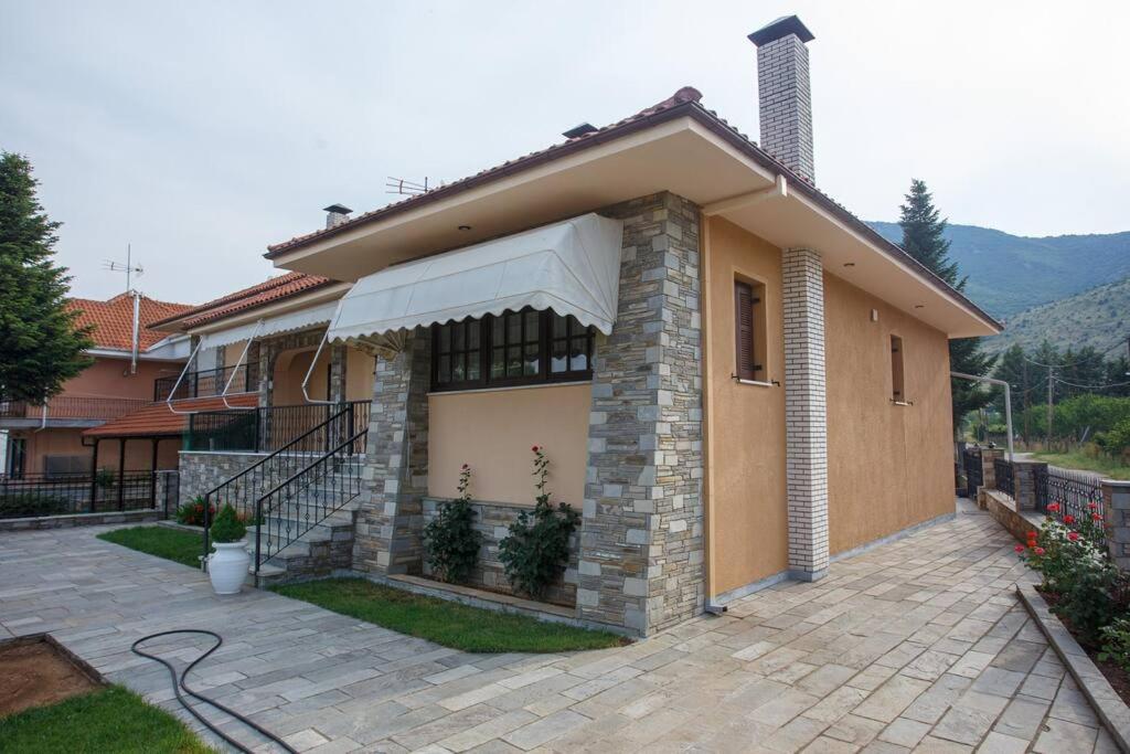 a house with an awning on the side of it at Βίλα για όλες τις εποχές του χρόνου in Kozani
