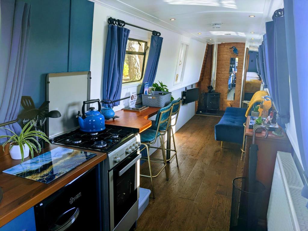 a kitchen with a stove and a kitchen with a counter at Haw thorn Hideaway in Doncaster