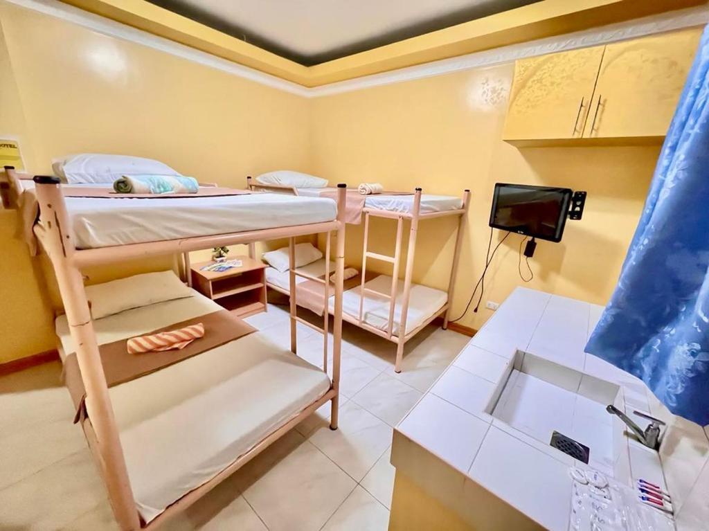 Postel nebo postele na pokoji v ubytování Wency Amor Hotel
