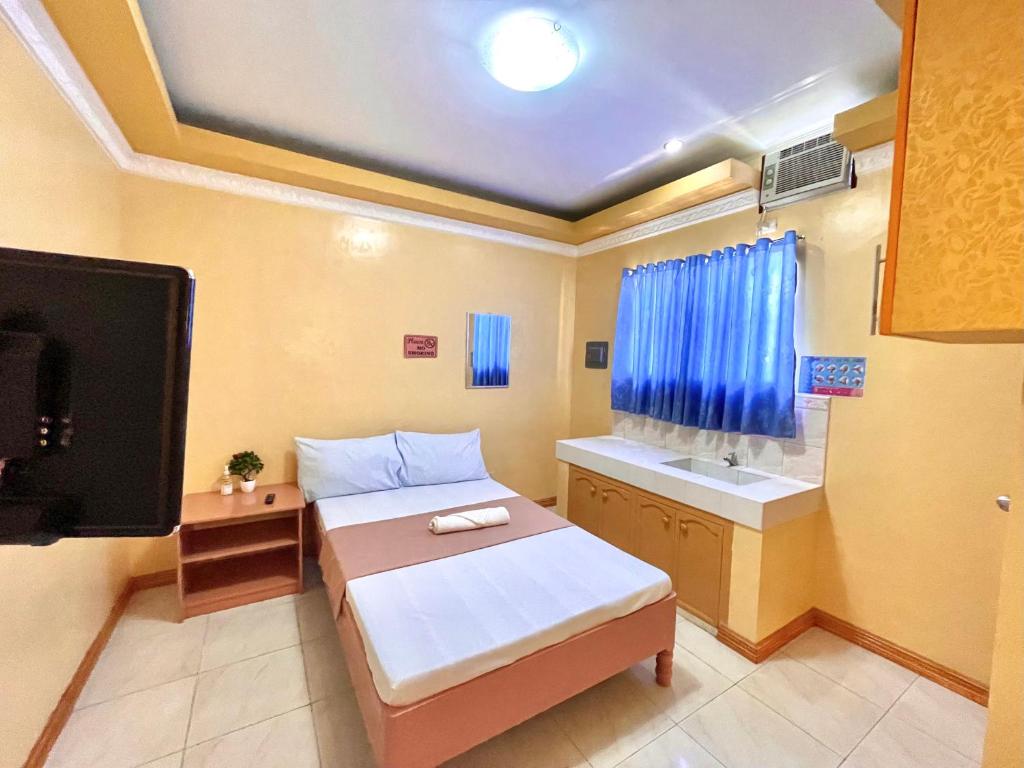 Postel nebo postele na pokoji v ubytování Wency Amor Hotel