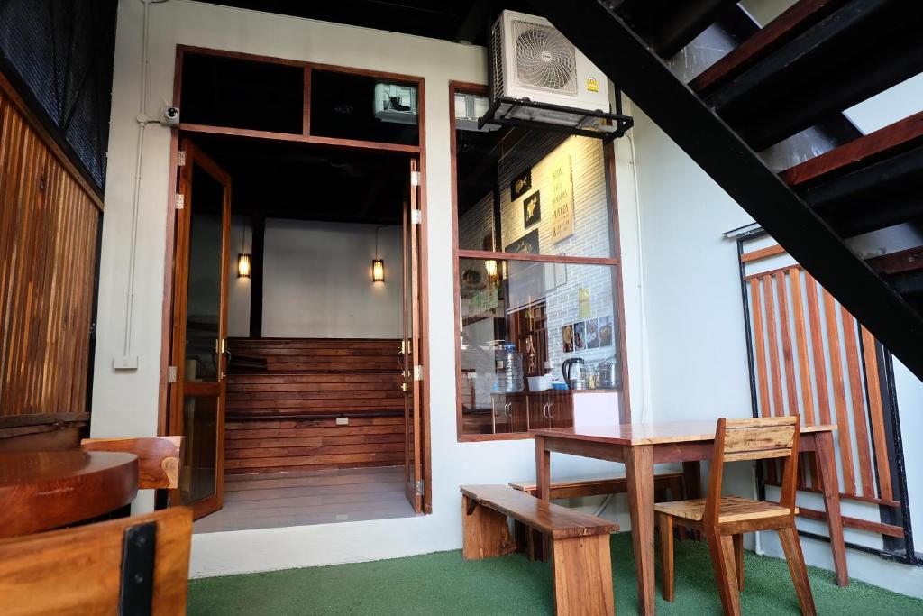 a room with a table and chairs and a window at Bloom Cafe & Hostel in Ko Lipe