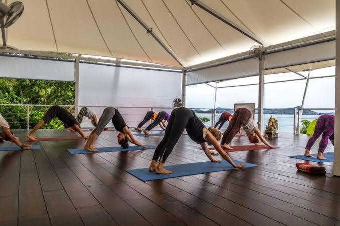a group of people doing yoga in a gym at Hi coral cove bungalow in Chaweng Noi Beach
