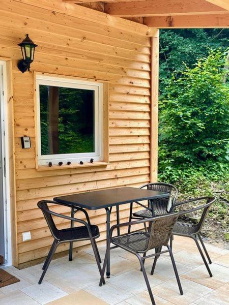 a black table and two chairs on a patio at Ferienhaus Sandsteinwandblick in Schöna