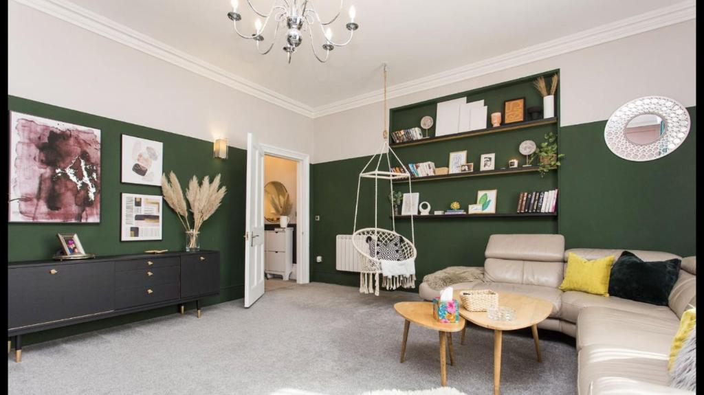 a living room with green walls and a couch at Grand Apartment in Historic Building with Free Parking in Kent