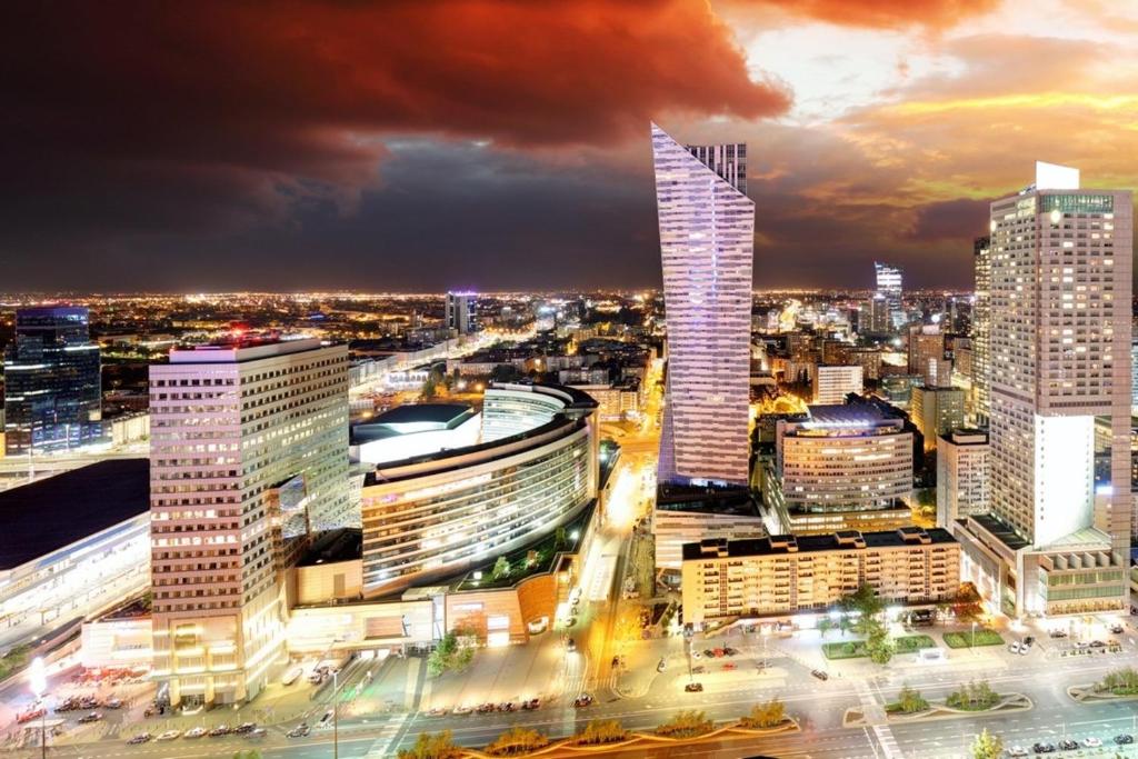 a view of a city skyline at night at Apart Rooms City Centre in Warsaw