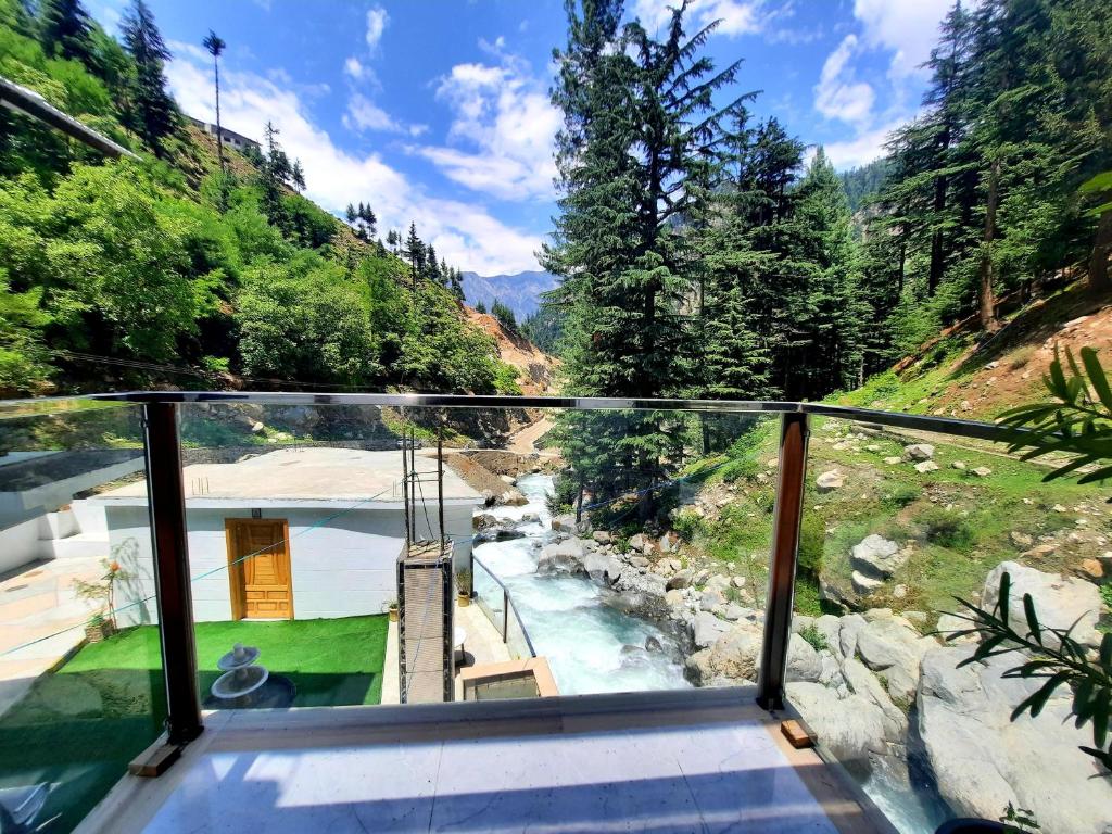 a view of a river from the balcony of a house at Blue Water Resort Kalam in Kārandūkai
