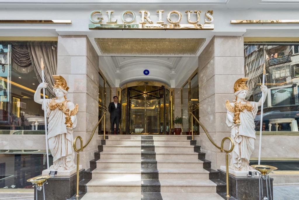 a man walks down the stairs of a luxury building at Glorious Hotel in Istanbul