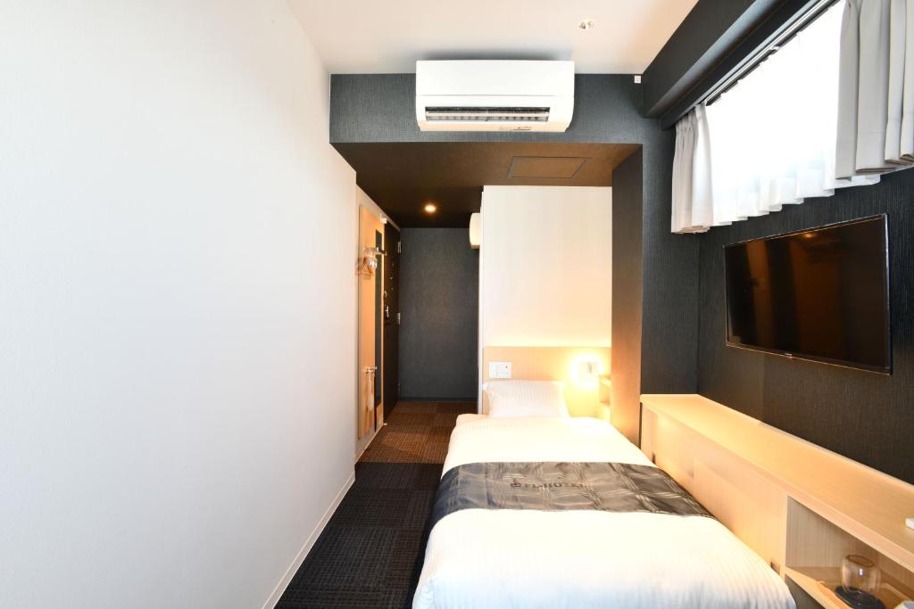 Postel nebo postele na pokoji v ubytování FL Hotel Asakusa