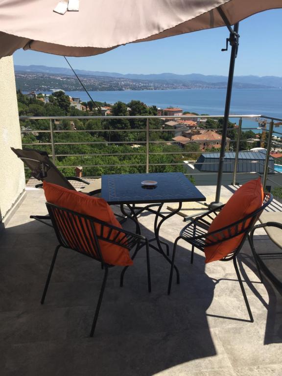 a table and chairs on a balcony with a view at Vacation Home Lucija in (( Slatina ))