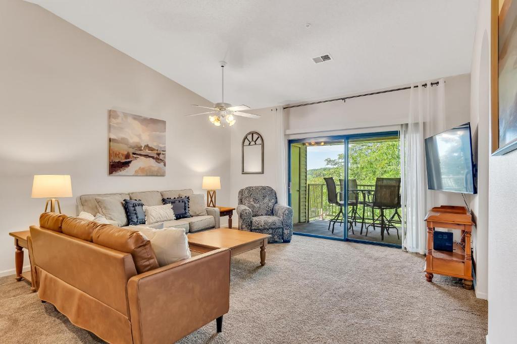 a living room with a couch and a table at Suite Spot at the Foothills condo in Branson