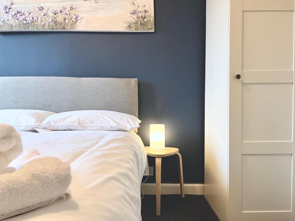 a bedroom with a bed with a candle on a table at Roost Hill Guest House - Free Parking in Edinburgh