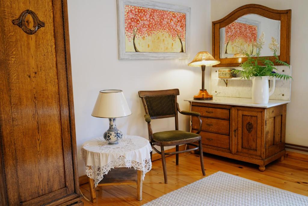 a room with a table and a chair and a mirror at Leśne Piętro in Sędziszowa