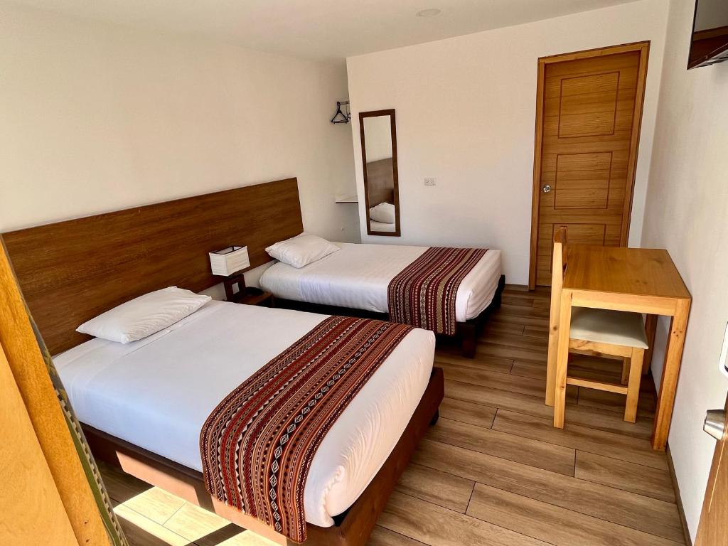 Postel nebo postele na pokoji v ubytování Hotel El Geranio