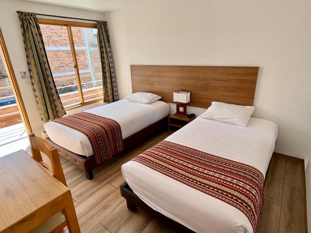 Postel nebo postele na pokoji v ubytování Hotel El Geranio
