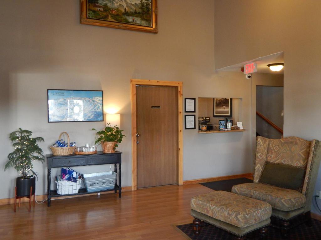 a living room with a chair and a door at Alpine Inn in Pagosa Springs