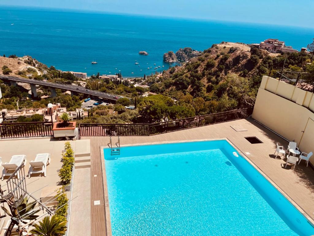 a swimming pool with a view of the ocean at Little Paradise in Taormina