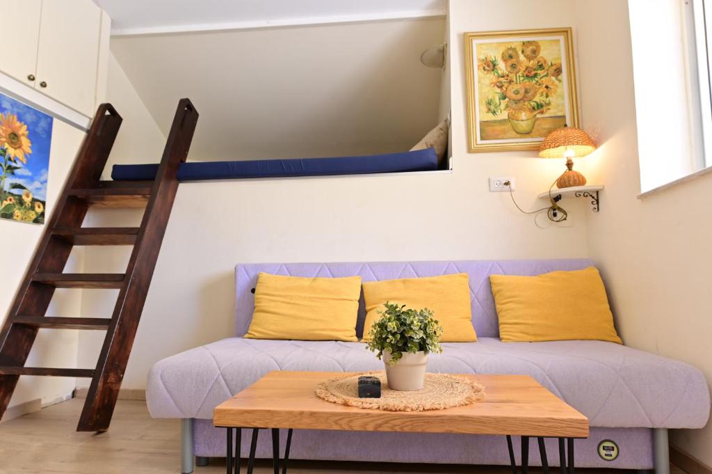 a living room with a couch and a table at Sweet Home, Only 7 Min to the beach - By SEAELO EILAT in Eilat