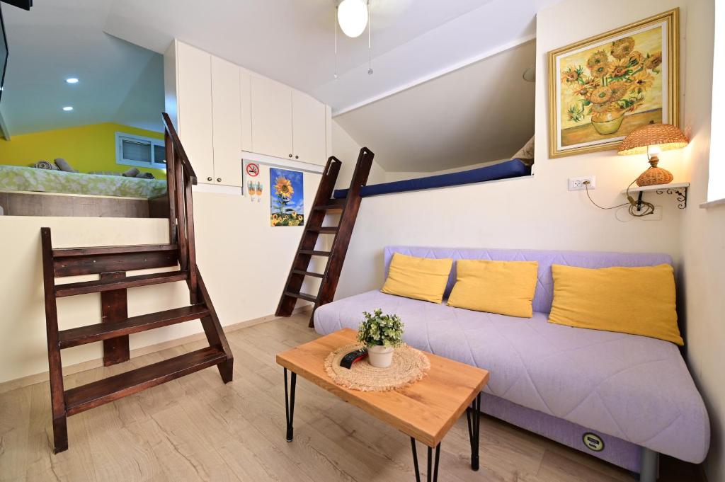 a small living room with a couch and a table at Sweet Home, Only 7 Min to the beach - By SEAELO EILAT in Eilat