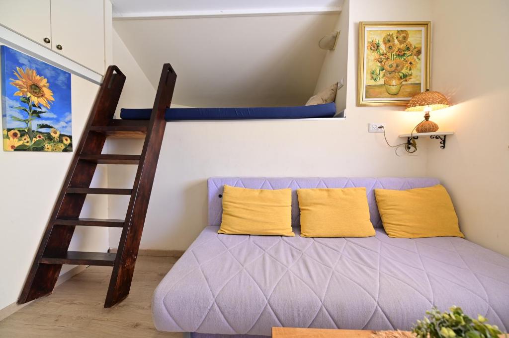 a bedroom with a bunk bed and a ladder at Sweet Home, Only 7 Min to the beach - By SEAELO EILAT in Eilat