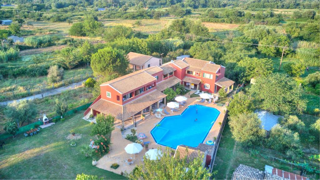 an aerial view of a house with a swimming pool at Blue Dream Apartments in Velonádes