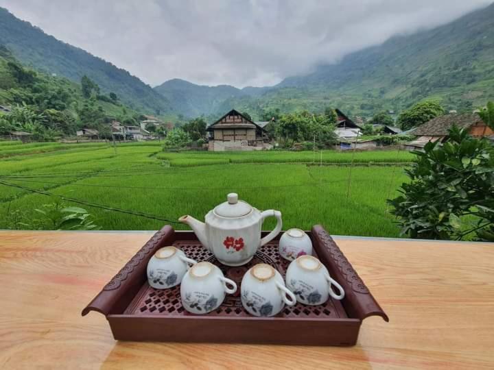 a tea set on a tray with a tea pot at Organic Farm Homestay in Sa Pa