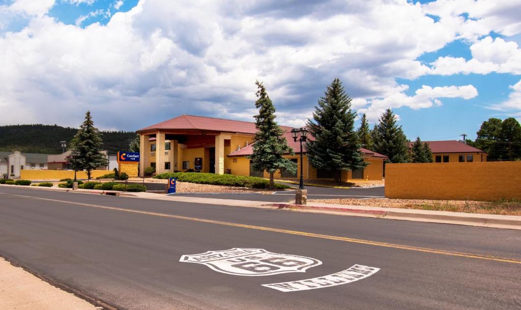a street scene with a car parked on the side of the road at Comfort Inn Near Grand Canyon in Williams